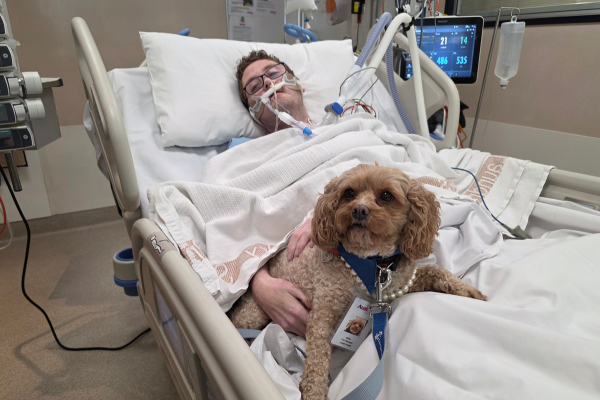 Austin Health ICU patient Robert with Lort Smith Pet Therapy dog Molly